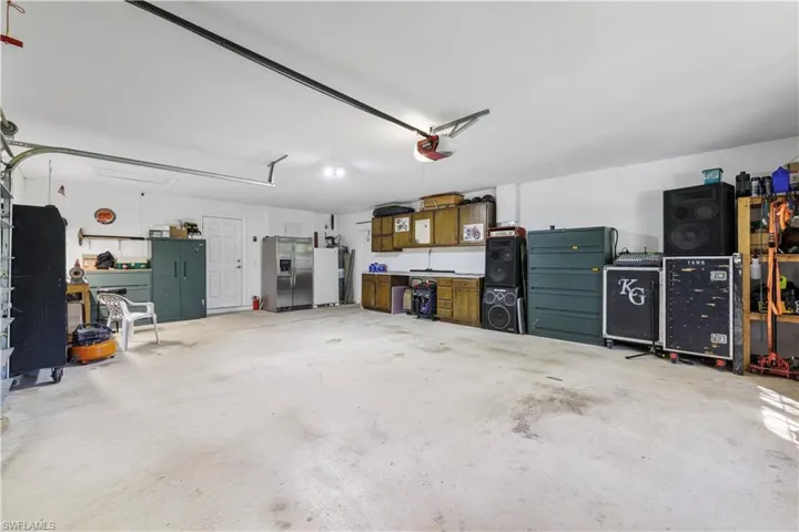 Garage featuring stainless steel fridge with ice dispenser