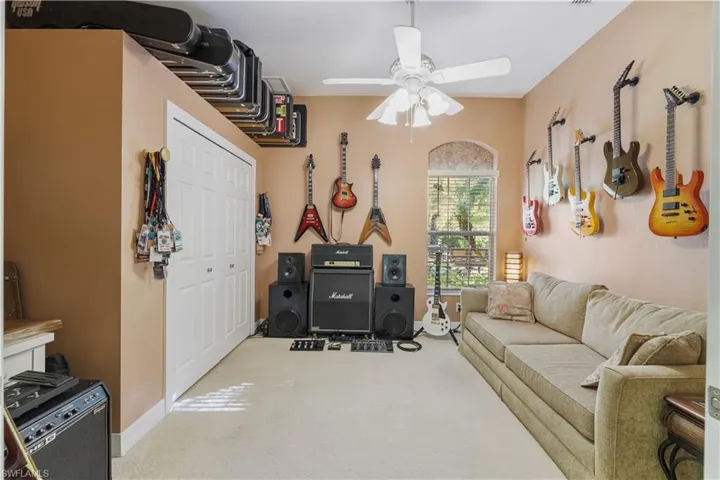 Living area featuring carpet and ceiling fan