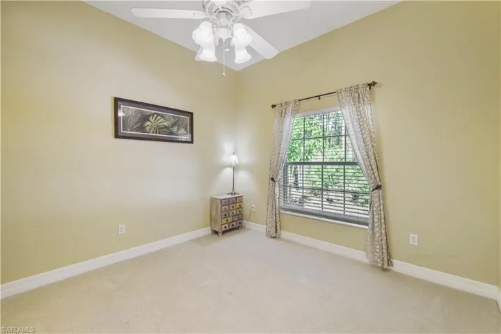 Unfurnished room featuring carpet flooring and a ceiling fan