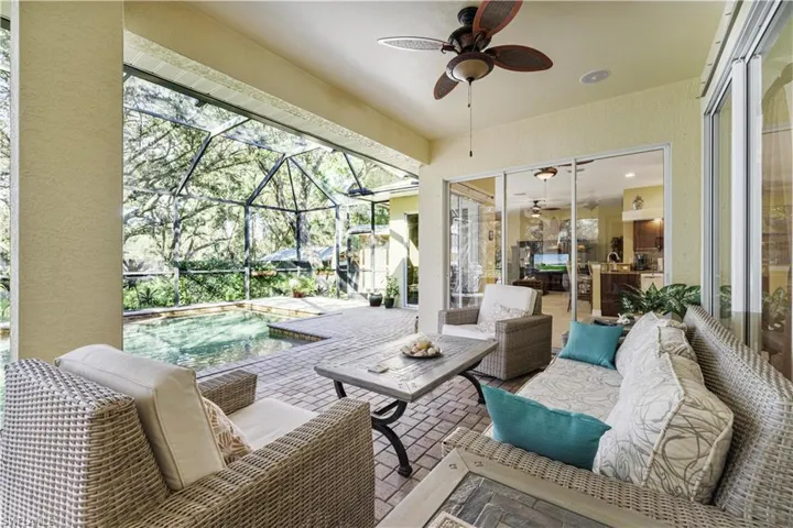 Sunroom featuring a patio, a ceiling fan, and outdoor lounge area