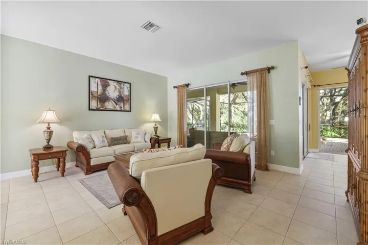 Living area with light tile patterned floors and baseboards