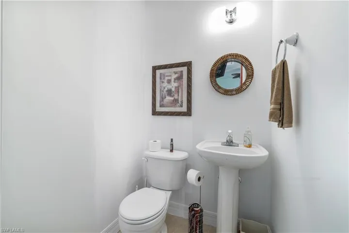 Half bath with toilet and baseboards