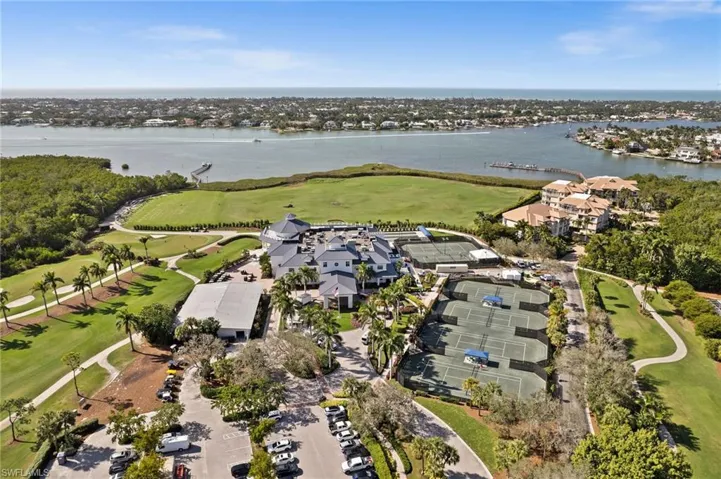 Aerial view of property's location with a large body of water and a golf club