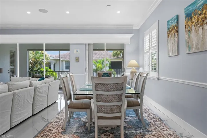 Dining area with marble finish flooring, plenty of natural light, crown molding, and recessed lighting