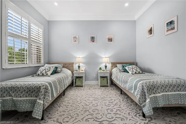 Bedroom featuring light colored carpet, crown molding, and recessed lighting