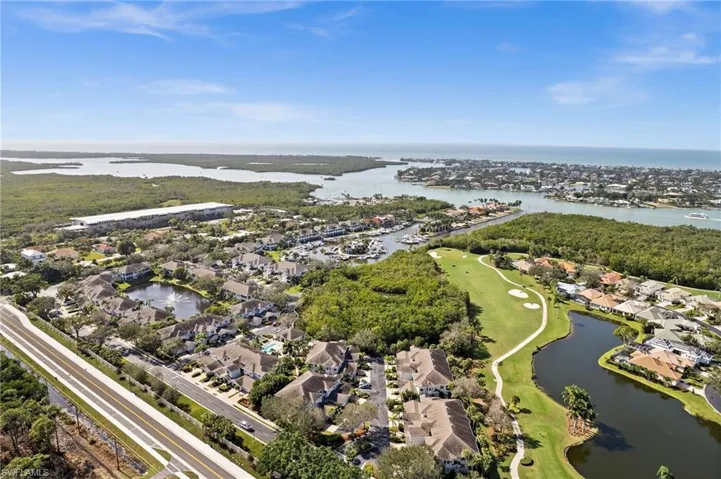 Aerial view of property and surrounding area with nearby suburban area and a nearby body of water