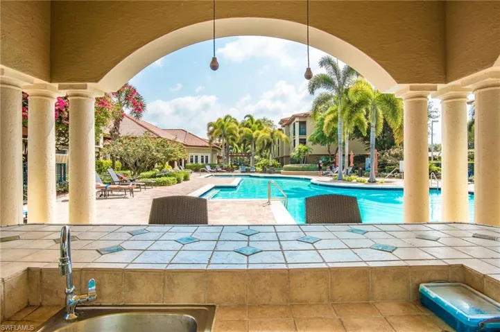 Community pool with a patio area and a sink
