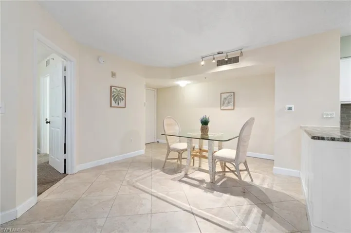 Dining space featuring light tile patterned floors, visible vents, and baseboards
