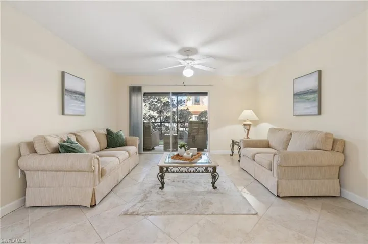 Living room with a ceiling fan and baseboards