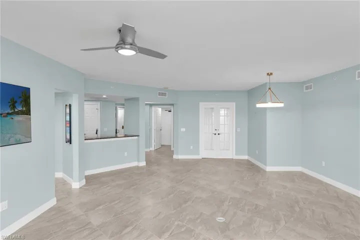 Unfurnished living room with french doors and a ceiling fan