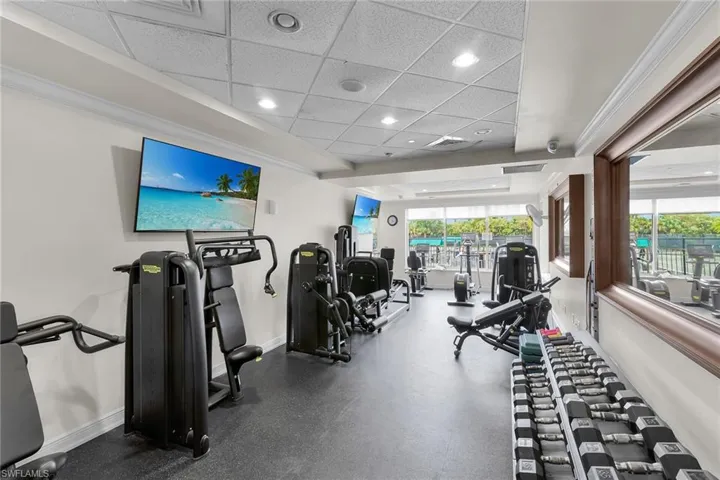 Exercise room with a paneled ceiling and recessed lighting