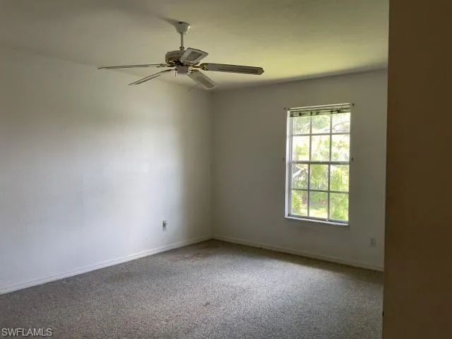 Spare room with carpet flooring and ceiling fan