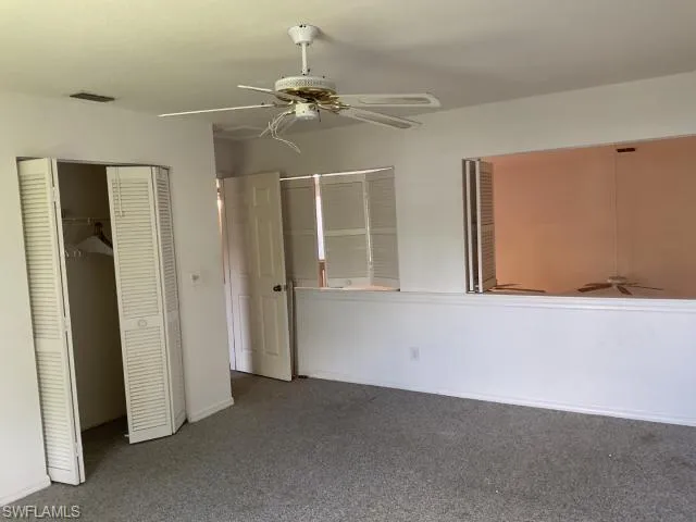 Unfurnished bedroom with a closet, carpet floors, and ceiling fan