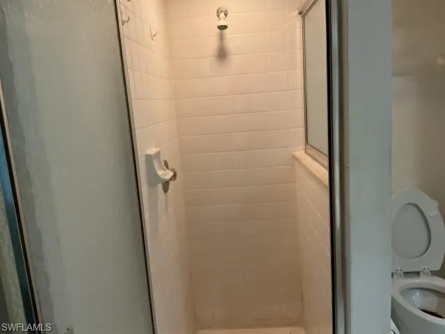 Bathroom with toilet and a stall shower