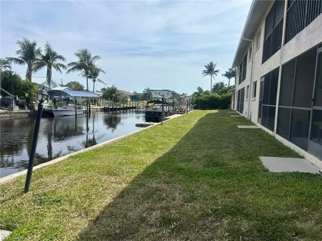 View of yard featuring a water view and a boat dock