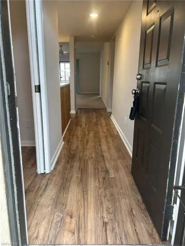 Hall featuring baseboards and wood finished floors
