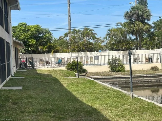 View of yard with a patio and fence