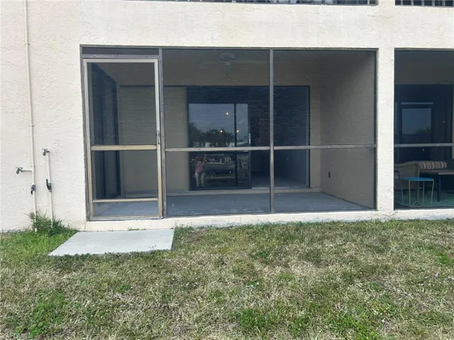 Doorway to property featuring stucco siding