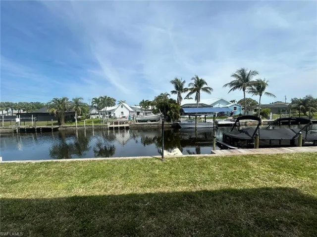 Water view featuring a residential view and a boat dock