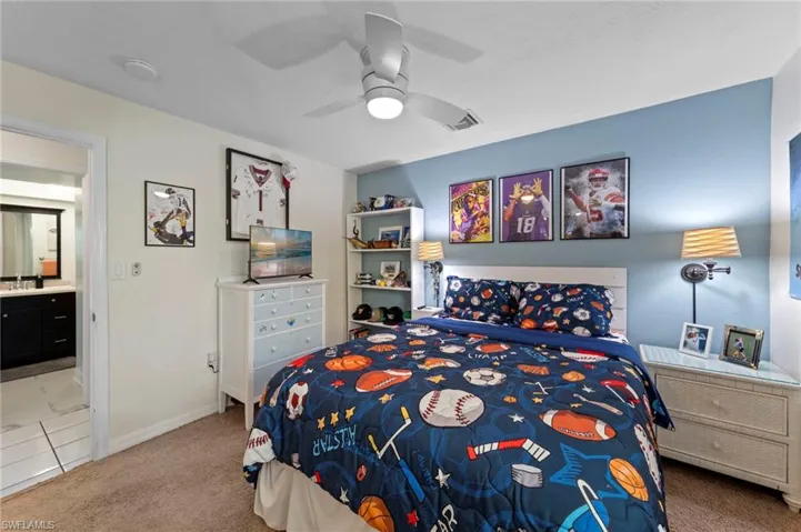Recessed lighting, ceiling fan with integrated light, light-colored carpeting, built-in shelving, and direct bathroom access