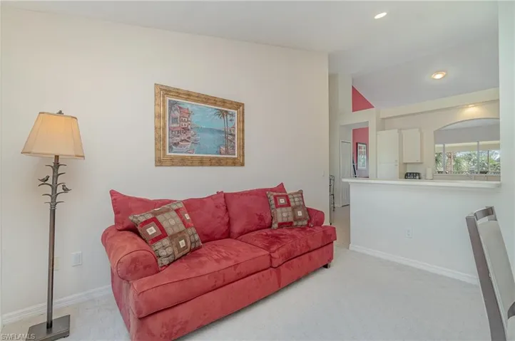 Open den with view of kitchen