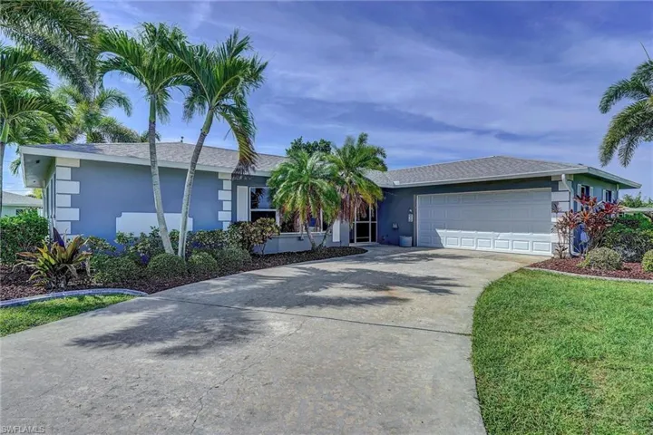 Ranch-style home featuring concrete driveway, stucco siding, a garage, and a shingled roof