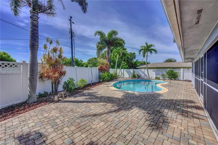 View of swimming pool featuring a fenced backyard and  screened patio