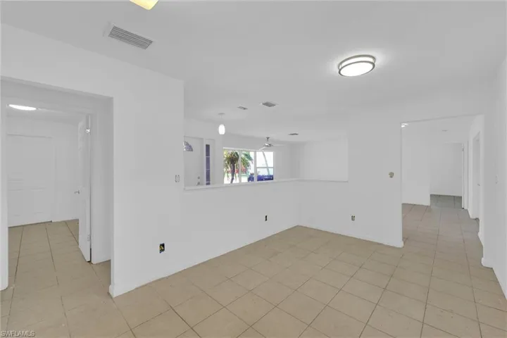 Spare room featuring ceiling fan and light tile patterned flooring
