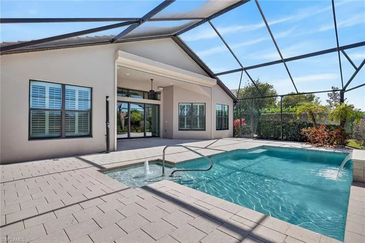 Pool with water features. Lanai Hurricane Shutters. Outdoor shower.