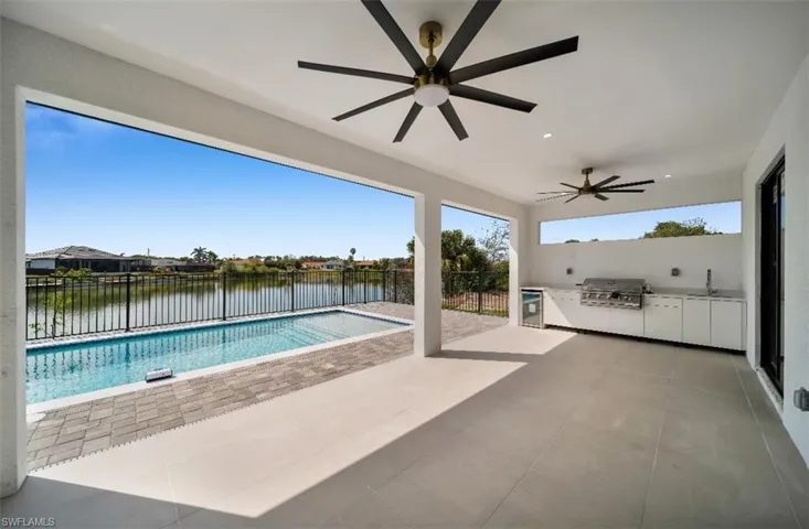 View of pool with area for grilling, sink, a patio, and an outdoor kitchen
