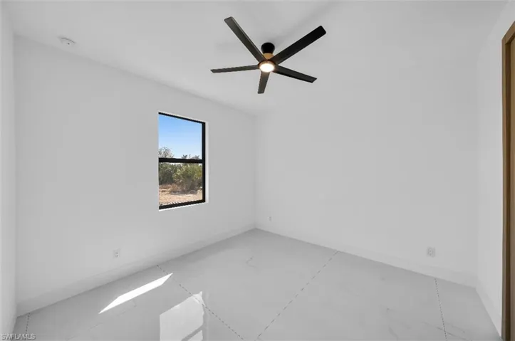 Empty room featuring ceiling fan