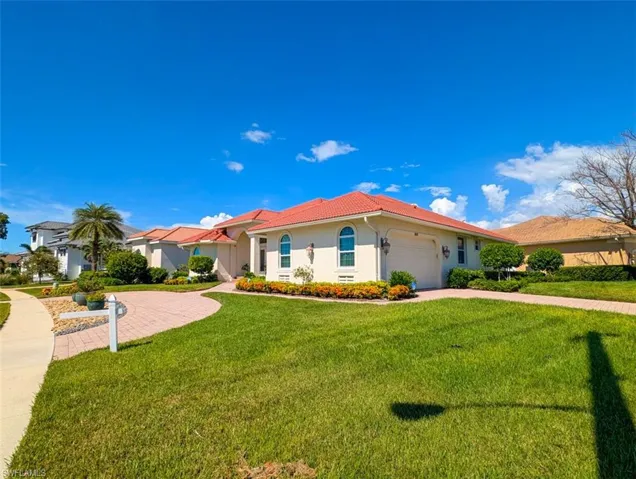 View of front of house with a front lawn and a garage