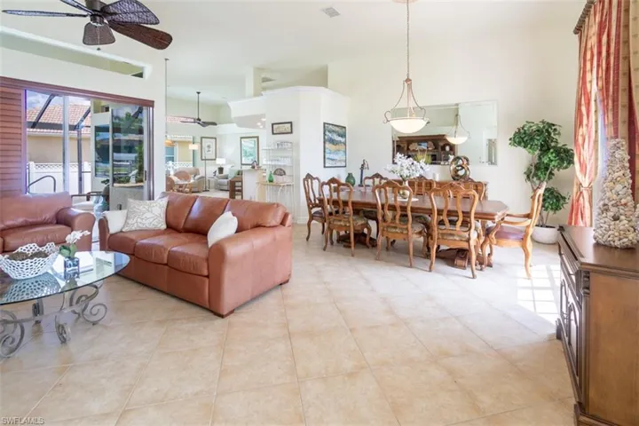 Living room with light tile patterned floors and ceiling fan