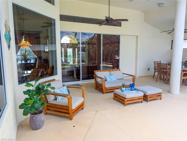 View of patio with ceiling fan and an outdoor living space