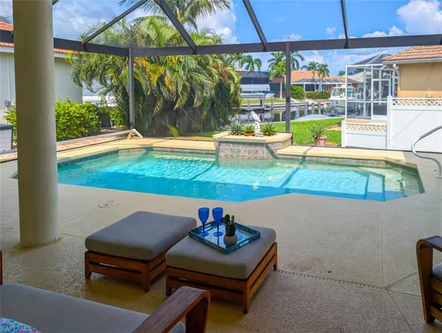 View of swimming pool featuring a patio and a lanai