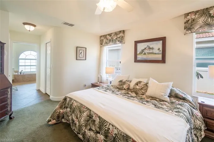 Tiled bedroom featuring a closet and ceiling fan