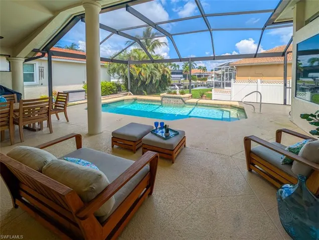 View of pool featuring a patio area, a lanai, and an outdoor living space