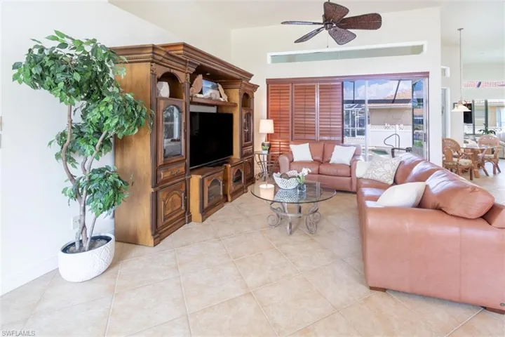 Living room featuring ceiling fan and light tile patterned floors