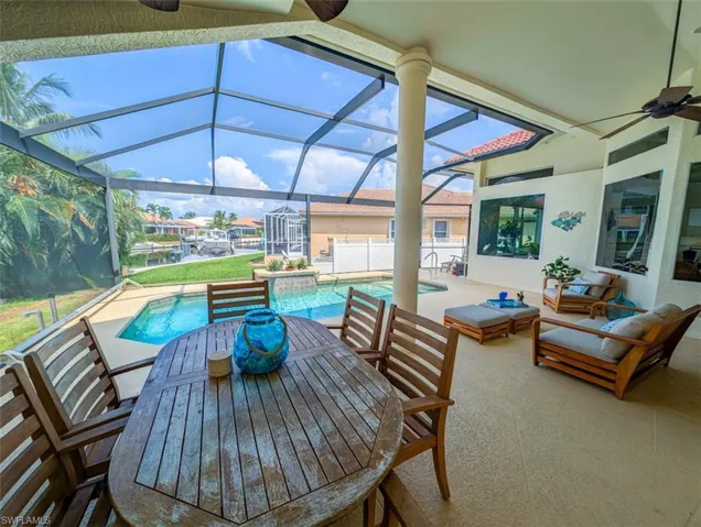 View of patio / terrace with glass enclosure, an outdoor living space, and ceiling fan