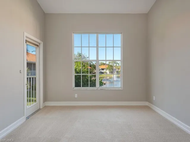 Carpeted Master Suite with a water view