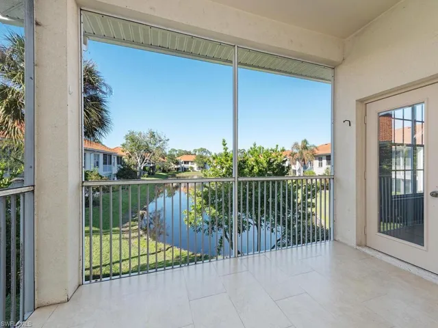 Unfurnished sunroom featuring a water view