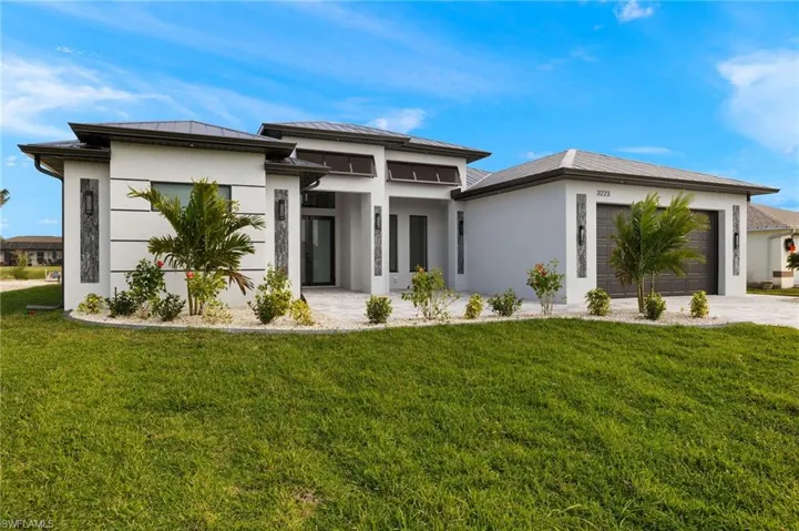 Prairie-style house with a garage and a front lawn