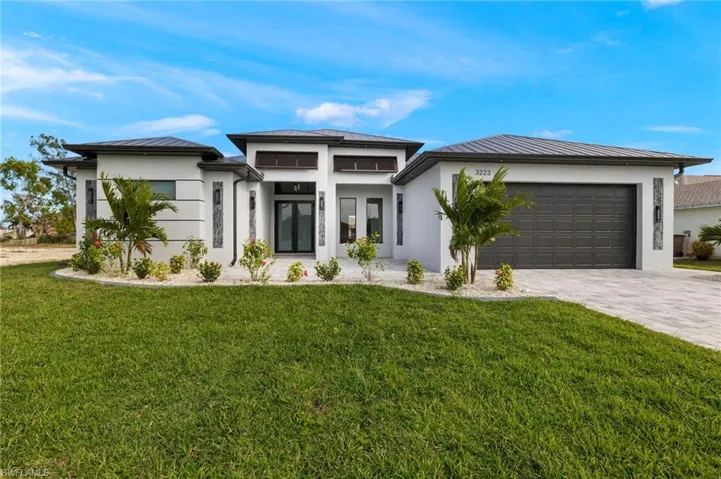 Prairie-style home featuring a garage and a front yard