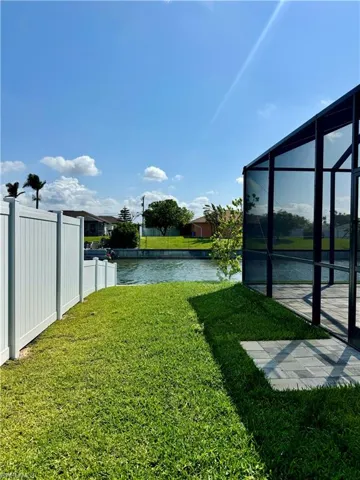 View of yard with a water view and a lanai