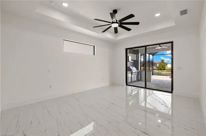 Empty room featuring a raised ceiling