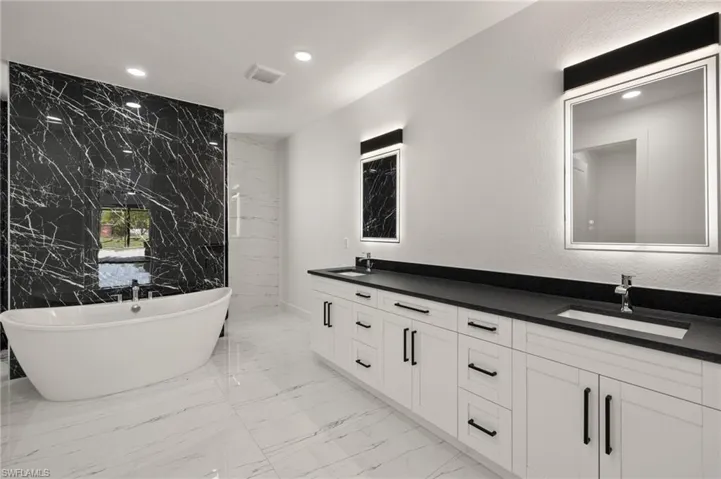Bathroom with vanity and a bathing tub