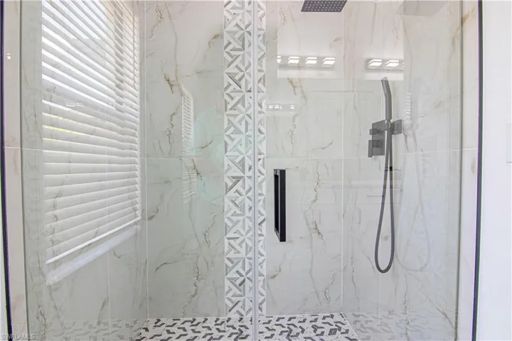 Bathroom featuring a marble finish shower