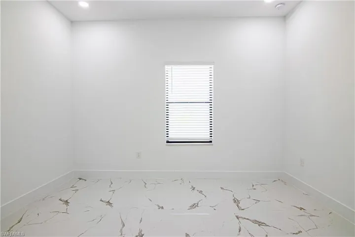 Unfurnished room featuring light marble finish flooring and recessed lighting