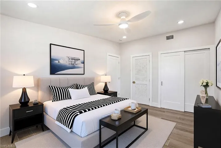This room features light-colored walls and wood-look flooring, complemented by recessed lighting and a ceiling fan - Virtually Edited Image