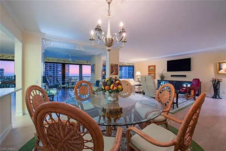 Dining room featuring a chandelier, ornamental molding, and wood finished floors
